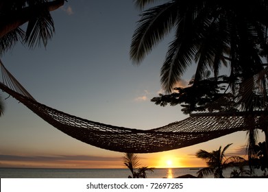 Hammock On Beach At Sunset In Fiji Islands