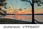 Hammock on rock beach looking at a beautiful sunrise over lake Ouachita