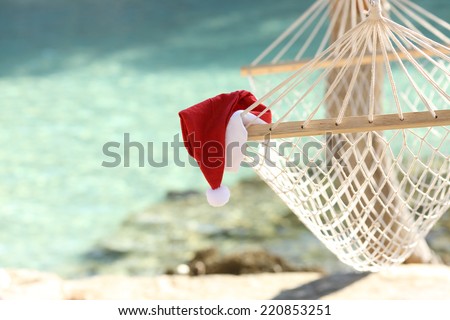 Hammock on a tropical beach resort in christmas holidays with the sea water in the background