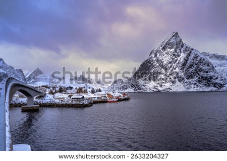 Hamnoy bridge covered with snow in winter, most popular iconic snowy bridge in Homnoy fisherman village, Lofoten Norway