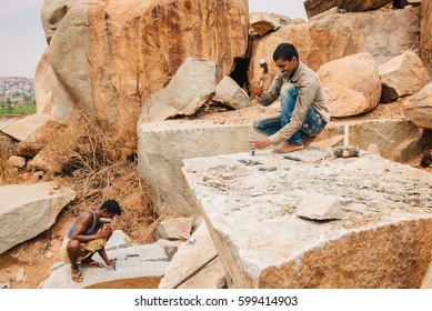 Hampi, India - March 1, 2016: Mining Workers Manually Excavating Stone With Hammer In Karnataka State Of India. Daily Life Of Indian Craftsman