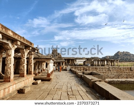 Hampi's temples in Karnataka, India, exemplify exquisite architecture and cultural richness, with iconic sites like the Virupaksha and Vitthala Temples standing out.
