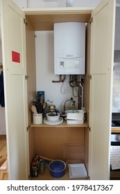 Hampshire England May 2021. LPG Gas Boiler In A Tall Kitchen Cupboard. Shelves Below With Kitchen Items. 