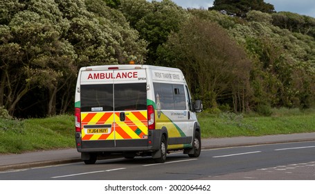 Hampshire, England, UK. July 2021, Ambulance Patient Transport Service Vehicle, Side And Rear View As It Travels On A Hampshire Road.