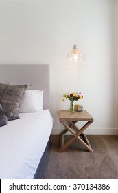 Hamptons Styled Bedside Table With Hanging Pendant Light In Luxury Home Interior