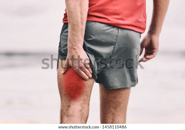 Hamstring\
pain pulled muscle on back thigh painful red area athlete man\
massaging sports injury fitness cramp\
muscles.