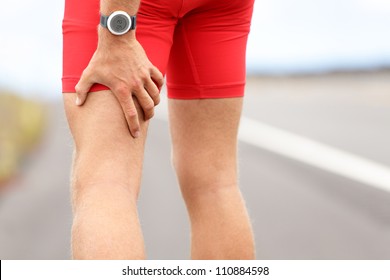 Hamstring Sprain Or Cramps. Running Sports Injury With Male Triathlete Runner.