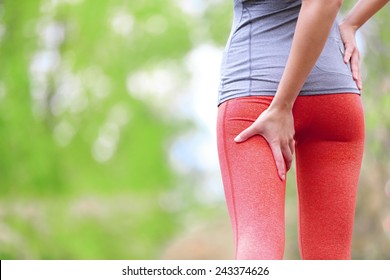 Hamstring sprain or cramps. Running sports injury with female runner. Closeup of woman back thigh.