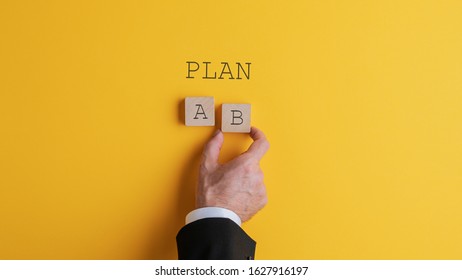 Han of a businessman choosing plan B in conceptual image. 
