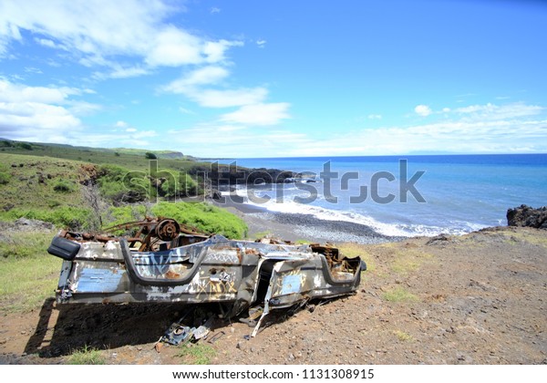 Hana, Hawaii / USA - March 28 2018 : Car flipped by\
the ocean