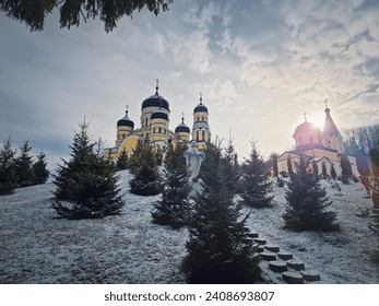Hancu Monastery outdoors winter view. Traditional Christian Orthodox church located in the middle of the snowy woods in Republic of Moldova. Eastern Europe basilica traditional architecture style