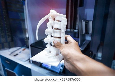 hand with 3d printed human spine in 3d printer. - Powered by Shutterstock