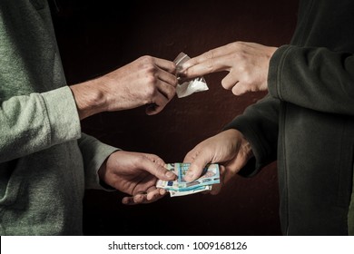 Hand Of Addict Man With Money Buying Dose Of Cocaine Or Heroine Or Another Narcotic From Drug Dealer. Drug Abuse And Traffic Concept.