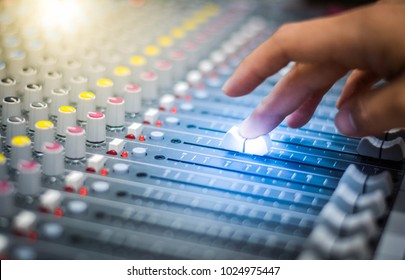 Hand adjusting audio mixer.Sound mixer controller.Sound mixer control for live music and studio equipment.This is a quality audio system for professionals. - Shutterstock ID 1024975447