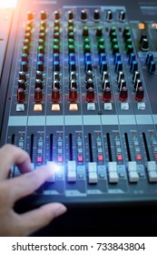 Hand adjusting audio mixer.Sound mixer controller.Sound mixer control for live music and studio equipment.This is a quality audio system for professionals.
