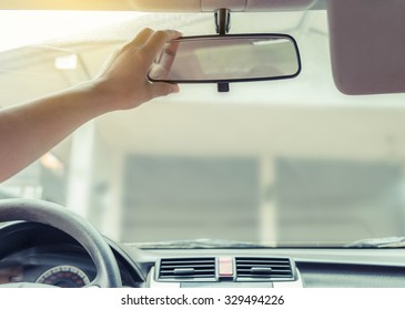 Hand adjusting rear view mirror. - Shutterstock ID 329494226