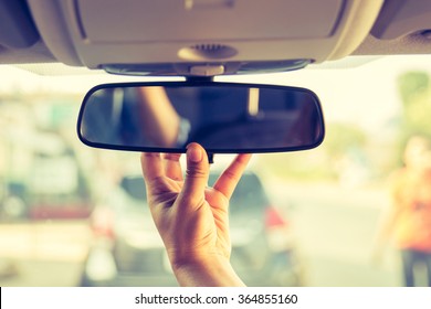 Hand adjusting rear view mirror. - Shutterstock ID 364855160