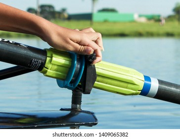 Hand Adjusting A Screw On A Rowing Skiff