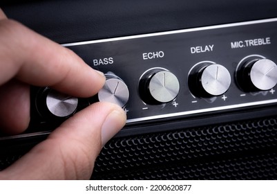 Hand Adjusting Volume Control.Use Hand To Adjust The Volume At The Volume Control Button Of The Amplifier.