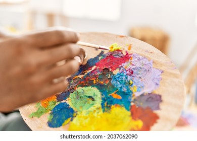 Hand of african american artist man mixing color on palette at art studio. - Shutterstock ID 2037062090