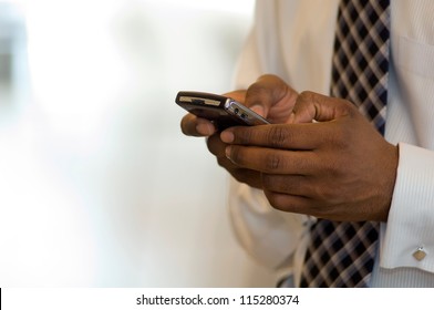 Hand Of An African American Businessman Holding A Mobile Phone