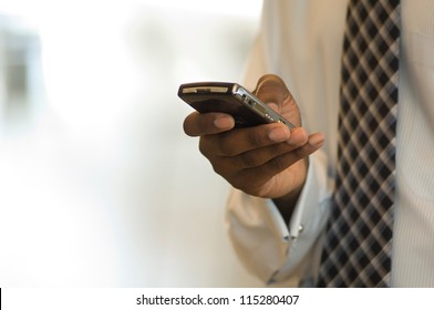 Hand Of An African American Businessman Holding A Mobile Phone