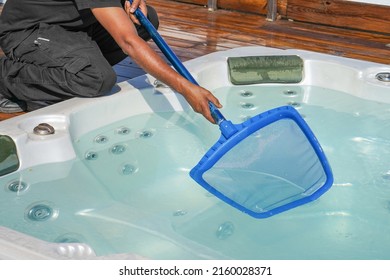 Hand Of African Maintenance Hotel Staff Worker Cleaning Hot Tub