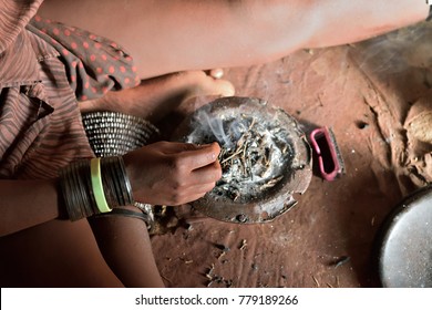 Hand of african native witch, close-up, cooking potion from a variety of ingredients