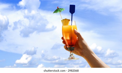 A Hand Against A Cloudy Sky, Holding A Tropical Drink