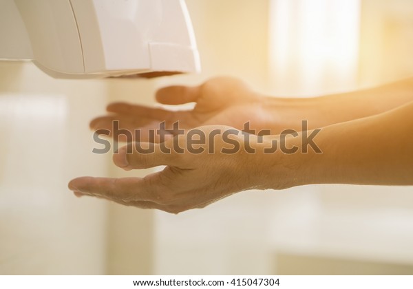Hand Air Dryer In Public Toilet or\
Washrooms,selective focus,vintage\
color
