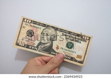 Hand with american dollars isolated on white