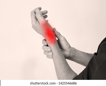 Hand Anatomy With Red Highlight On Wrist Pain. Wrist Pain May Cause From Muscle Strain, Tendinitis, Ligament Sprain, Fracture, Nerve Entrapment Or Carpal Tunnel Syndrome Disease. Medical Symptom