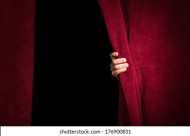 Hand appearing beneath the curtain. Red curtain. - Shutterstock ID 176900831