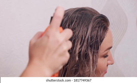 A Hand Applies A Protective Spray To Light, Wet Hair. Beauty Saloon. Professional Hair Care.