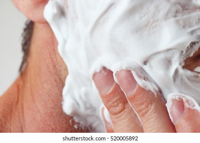 Hand Applies Shaving Foam On Face Close Up