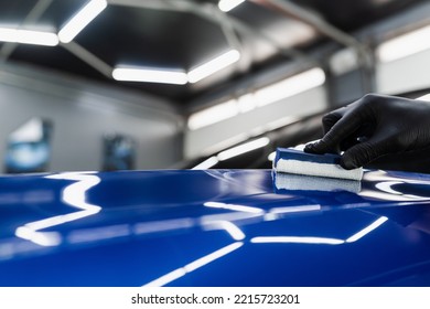 Hand Applying Of Nano Ceramic Protective Coat To Protect Car From Scratches. Process Of Apply Ceramic Layer On Body Car Using Sponge Close-up In Detailing Auto Service