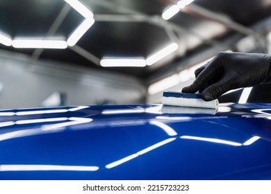 Hand Applying Of Nano Ceramic Protective Coat To Protect Car From Scratches. Process Of Apply Ceramic Layer On Body Car Using Sponge Close-up In Detailing Auto Service