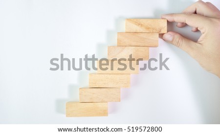 Hand aranging wood block stacking as step stair success