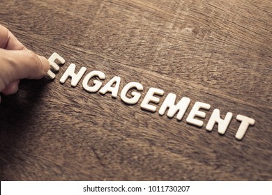 Hand arrange wood letters as Engagement word for marketing concept