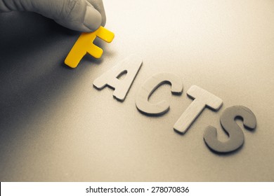 Hand Arrange Wood Letters As Facts Word