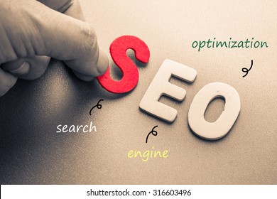 Hand arrange wood letters as SEO abbreviation (Search Engine Optimization)