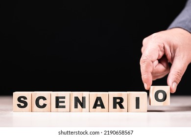 Hand arranges the alphabet wood cubes as Scenario word on the table - Shutterstock ID 2190658567
