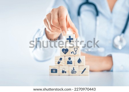 Hand Arranging Wood block With Health medical icon health insurance concept.