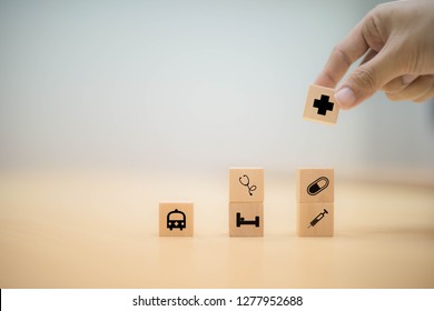 Hand arranging wood block stacking with icon healthcare medical, health concept - Shutterstock ID 1277952688