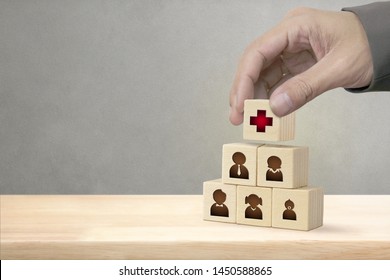 Hand arranging wood block stacking with icon healthcare medical in Family, Insurance for your health concept.
