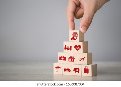 Hand Arranging Wood Block Stacking With Icon Insurance: Car,health,home,money,travel,family,insurance Concept.