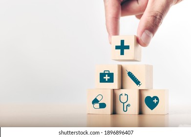 Hand Arranging Wood Block Stacking With The Healthcare Medical Icon. Health Insurance - Health Concept