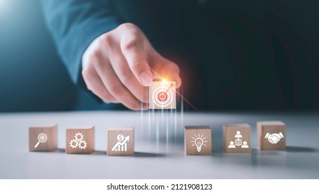 Hand arranging wood block stacking with business strategy and Action plan,targeting the business concept.business development concept. - Shutterstock ID 2121908123