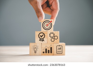 Hand arranging wood block stacking, showcasing the concept of business strategy and Action plan. Targeting the idea of success and goal attainment. - Shutterstock ID 2363078163