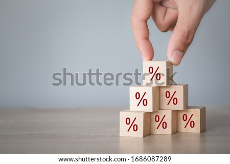 Hand arranging wood block stacking with icon percent symbol upward direction,